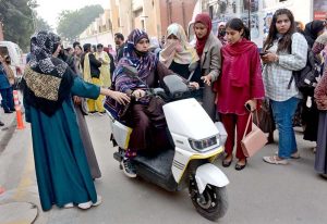Students ride electric scooters at a traffic safety camp set up by the Traffic Police at Government College Women’s University, Madina Town.