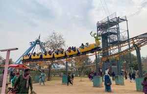 Children enjoy a train ride at Lake View Park as golden sunlight breaks through clouds over the federal capital.