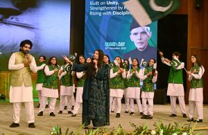 Artists with students performing national songs at a ceremony marking the birth anniversary of the Founder of Pakistan, Quaid-e-Azam Muhammad Ali Jinnah, at the Convention Centre.