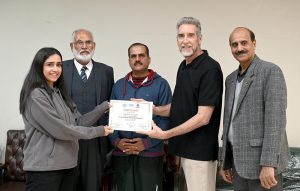 IVB Instructor Mr. Eric Aan distributes certificates among the participants at the Pakistan Volleyball Federation Closing Ceremony of the FIVB Coaches Training Program in Library Hall, Pakistan Sports Complex.