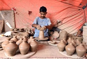 A worker preparing clay-made stuff at his work place near Kumharpara Jamshoro road.