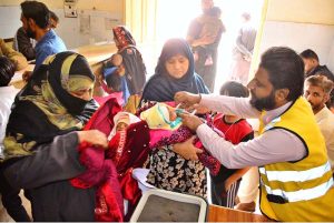 Health worker administering polio drops to a child during Anti-Polio Vaccination Campaign at Shah Bhitai Hospital
