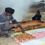 Farmers prepare the traditional sweet, jaggery (gur) during the sugarcane processing season at their workplace.