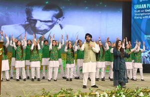 Artists with students performing national songs at a ceremony marking the birth anniversary of the Founder of Pakistan, Quaid-e-Azam Muhammad Ali Jinnah, at the Convention Centre.