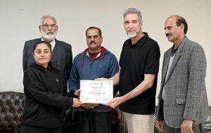 IVB Instructor Mr. Eric Aan distributes certificates among the participants at the Pakistan Volleyball Federation Closing Ceremony of the FIVB Coaches Training Program in Library Hall, Pakistan Sports Complex.