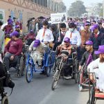 Special persons participate in an awareness walk at Kalma Chowk to mark the International Day of Persons with Disabilities