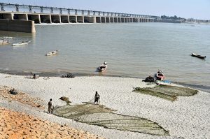 Women are busy washing the clothes at the bank of Indus River.