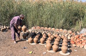 A worker preparing clay-made stuff at his work place near Kumharpara Jamshoro road.