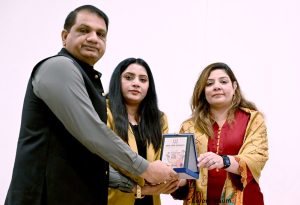 Sabeen Ghori, Parliamentary Secretary IT, presents a shield to Rana Imran Latif, Senior journalist, Anchorperson and chairman of Piyass International Human Rights, at the “Safe Her Growth” seminar at HITEC University Taxila.