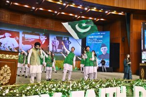 Artists with students performing national songs at a ceremony marking the birth anniversary of the Founder of Pakistan, Quaid-e-Azam Muhammad Ali Jinnah, at the Convention Centre.