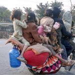 A nomad family travels with their belongings on a motorcycle along the Expressway in search of a place to settle in the federal capital