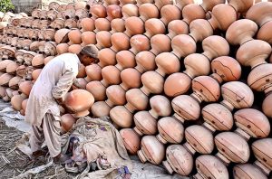 A worker preparing clay-made stuff at his work place near Kumharpara Jamshoro road.