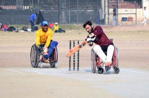 Special persons participate in an awareness walk at Kalma Chowk to mark the International Day of Persons with Disabilities