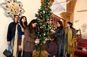 Girls decorate a Christmas tree at St. Thomas Church in Civil Colony ahead of the upcoming Christmas celebrations.