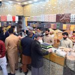 People purchase dry fruits in the provincial capital as the cold weather intensifies