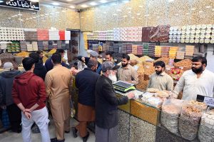 People purchase dry fruits in the provincial capital as the cold weather intensifies