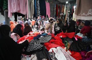 People busy selecting and purchasing second hand clothes from vendor at H-9 weekly Bazaar in the Federal Capital
