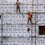 Workers engaged in construction at the Kalma Chowk PTCL building