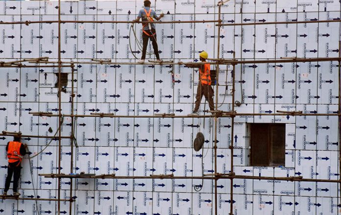 Workers engaged in construction at the Kalma Chowk PTCL building