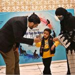Renowned child specialist Dr. Khawaja Arshad awards a differently-abled child during a ceremony held in connection with the International Day of Persons with Disabilities organized by Adil Special School and Rehabilitation Center at a private hotel