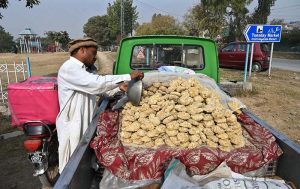 A vendor displays traditional sweet jaggery on his van outside the I-9/4 weekly bazaar in the Federal Capital.