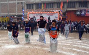 Students are participating in a sack race during the closing ceremony of Annual Sports Gala 2025 at PMDC Dalazak.