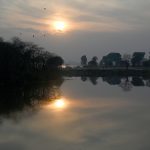 A breathtaking sunset over Lake View Park provides a dramatic view for visitors enjoying the evening.