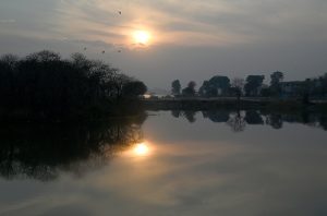 A breathtaking sunset over Lake View Park provides a dramatic view for visitors enjoying the evening.