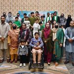 Staff members and students of Adil Special School and Rehabilitation Center pose for a group photo during a ceremony held to mark the International Day of Persons with Disabilities organized by Adil Special School and Rehabilitation Center at a private hotel
