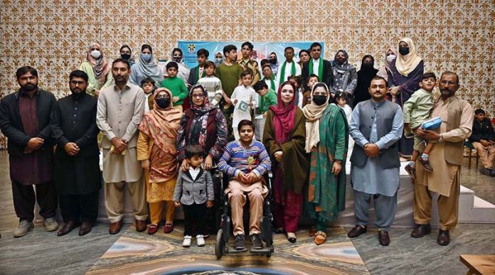 Staff members and students of Adil Special School and Rehabilitation Center pose for a group photo during a ceremony held to mark the International Day of Persons with Disabilities organized by Adil Special School and Rehabilitation Center at a private hotel