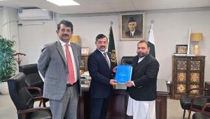 Federal Minister for National Heritage and Culture Division Aurangzeb Khan Khichi presents a book to Rector NUML Maj. Gen(Retd) Shahid Mahmood Kayani.