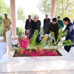 President Asif Ali Zardari lays flowers on the grave of his father, Sardar Hakim Ali Zardari, at Baloo Ja Quba
