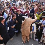 A large group of youngsters perform Sindhi dance wearing traditional Sindhi caps during Sindhi Culture Day outside the Press Club