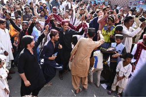 A large group of youngsters perform Sindhi dance wearing traditional Sindhi caps during Sindhi Culture Day outside the Press Club