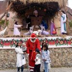 Children pose for photographs with Santa Claus at the historic St. Francis of Assisi Church.