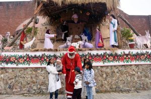 Children pose for photographs with Santa Claus at the historic St. Francis of Assisi Church.