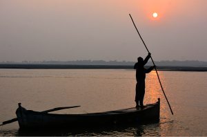 The final sunset of 2025 melts into the River Indus, painting the waters with gold, fire, and quiet reflection.