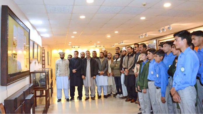Students and faculty members of Government Boys High School Jaglari pose for a group photograph in the Senate Hall at Parliament House