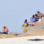 Gypsy women busy in washing clothes along the Indus River