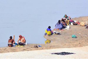 Gypsy women busy in washing clothes along the Indus River