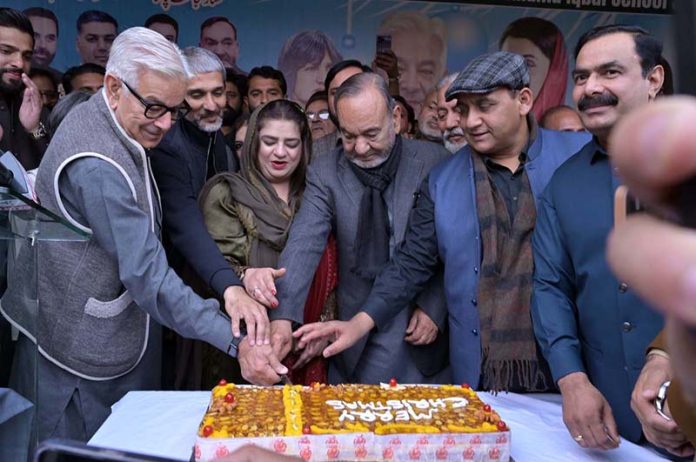 Defense Minister Khawaja Muhammad Asif and Mansha Ullah Butt, Minister for Labour and Human Resources Punjab, along with others, cut the Christmas cake during a ceremony organized by the PML-N Minority Wing
