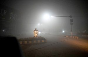 Fog engulfs the city at night, reducing visibility.