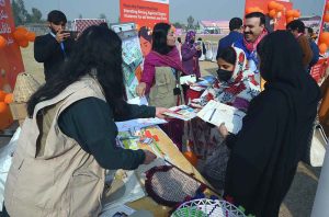 Female visitors explore various stalls during the 16 Days of Activism event at Hayatabad Sports Complex, highlighting unity, hope, and a collective commitment to end violence against women and girls