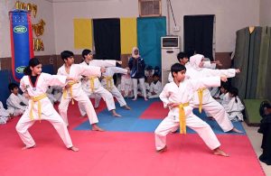 Martial arts students demonstrate their skills during the Belt Promotion Ceremony at the Karate Academy, University of Sargodha.