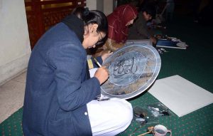 Students engage in calligraphy during a competition at Nusrat Fateh Ali Khan Auditorium of the Arts Council in the city’s textile hub.