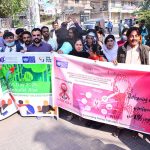 Civil society participants take part in an awareness walk on World AIDS Day outside the Press Club