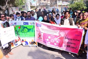 Civil society participants take part in an awareness walk on World AIDS Day outside the Press Club