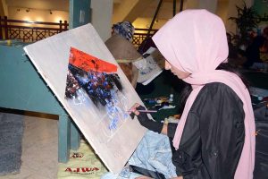 Students engage in calligraphy during a competition at Nusrat Fateh Ali Khan Auditorium of the Arts Council in the city’s textile hub.