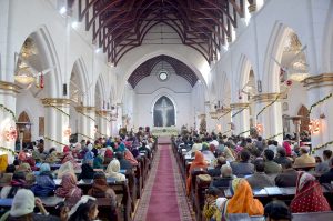 Christian community members performing religious rituals on Christmas Day at St. John Cathedral Church.
