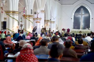 Christian community members performing religious rituals on Christmas Day at St. John Cathedral Church.